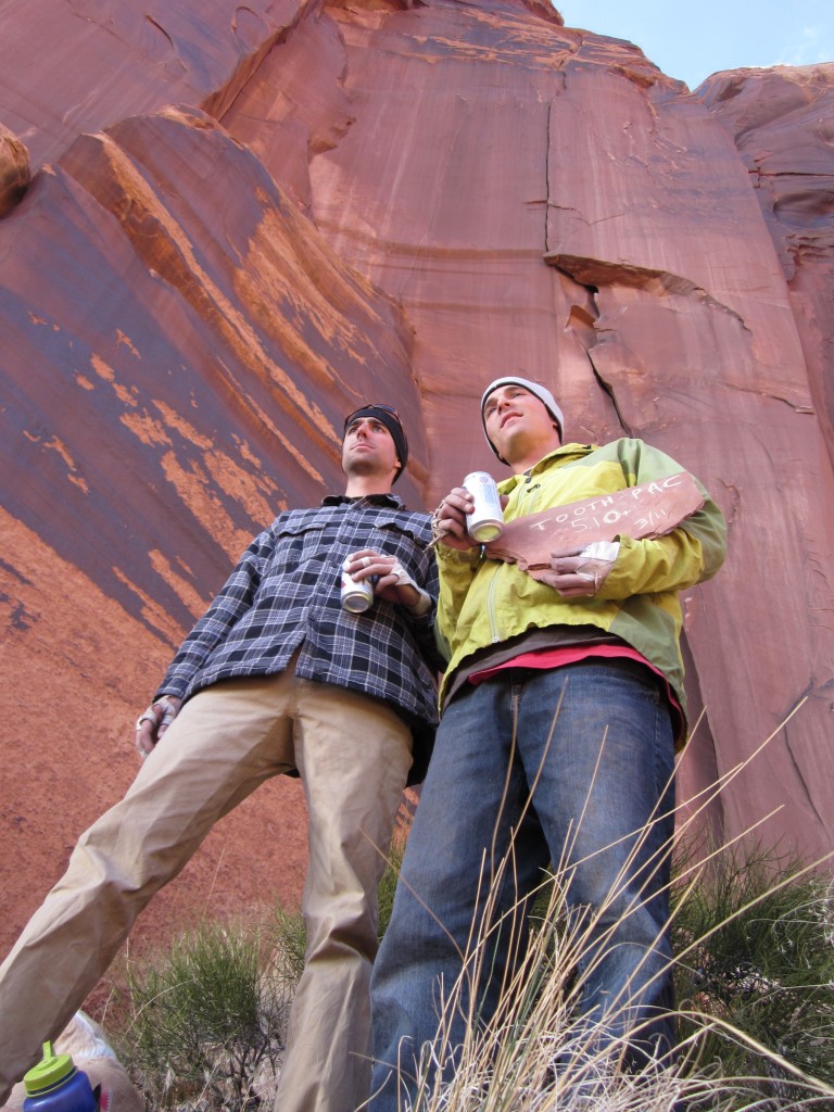 Keith Brett (left) and Mehall in their b-boy stances after the first ascent of Tooth Pac (5.10+) in Indian Creek, Utah in 2011. The name of the route is a tribute to the late rapper 2 Pac. The climb is located on the Broken Tooth Wall. The splitter they are standing under is the namesake route of the wall, Broken Tooth, a classic 5.12-. 